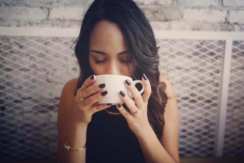 A woman drinking coffee over break