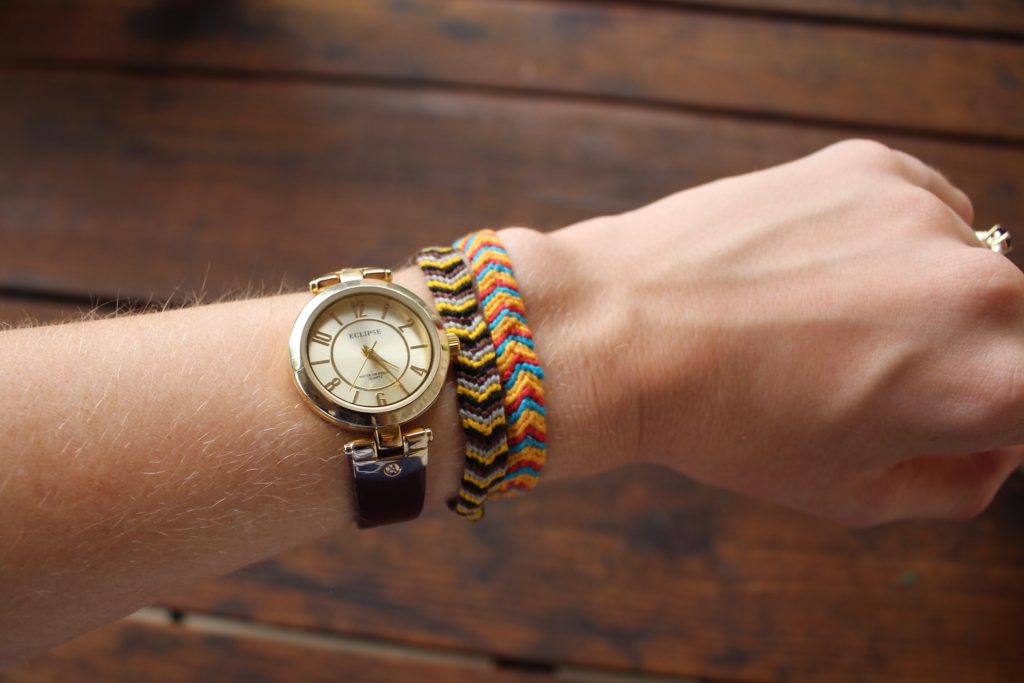 Wrist watch and bracelets on an arm