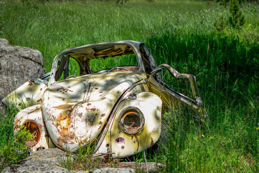 An old beetle car that has gone through a car accident