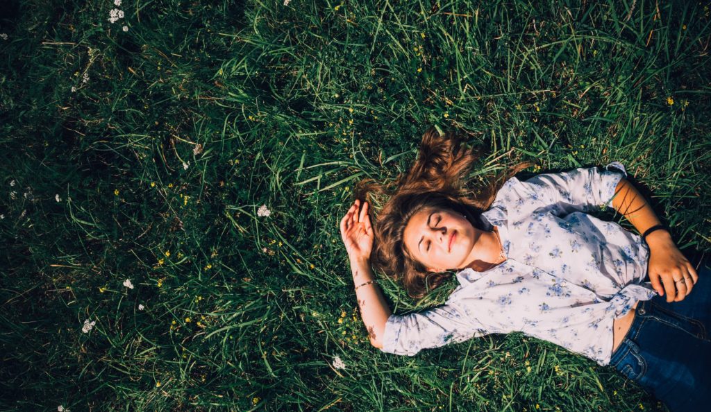 Woman lying relaxed in a field