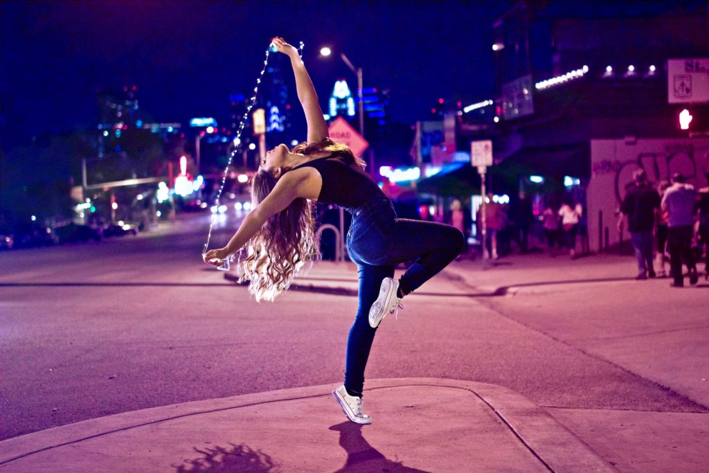 Woman dancing on the streets at night