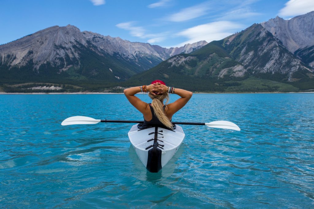 Person relaxing in a kayak on a lake