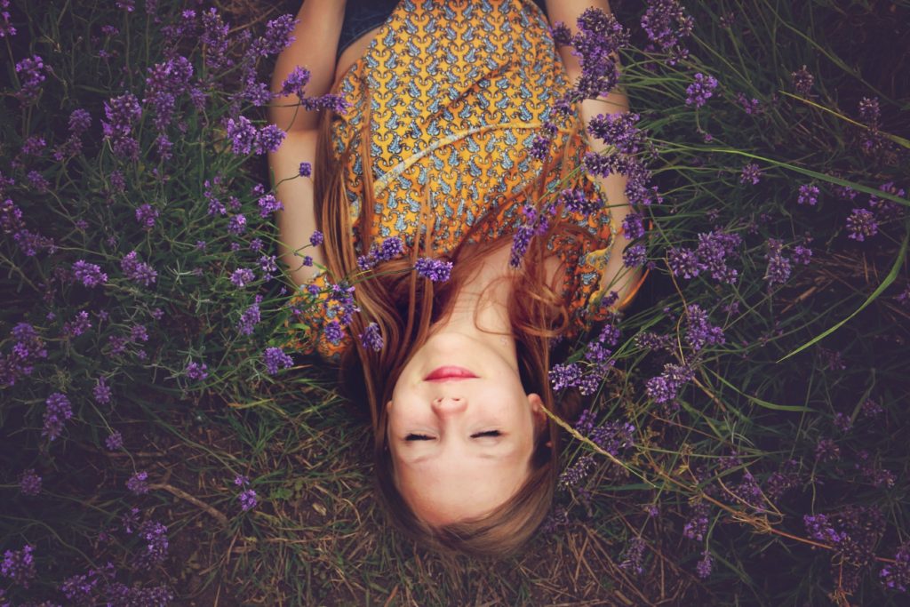 Woman sleeping in a field of flowers