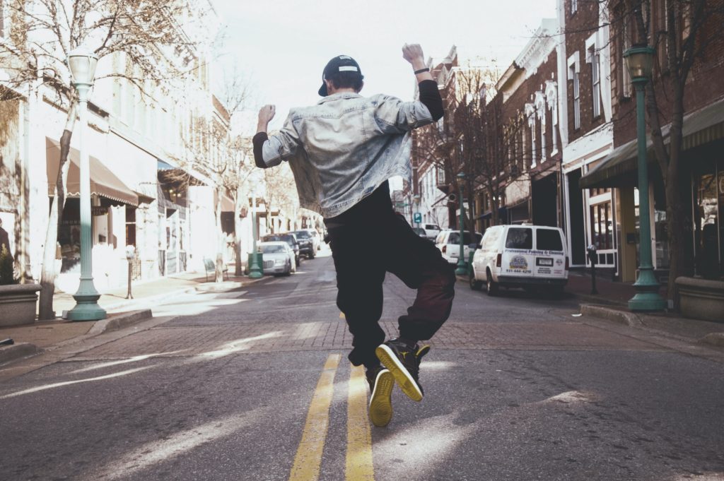 Man jumping in the street in joy