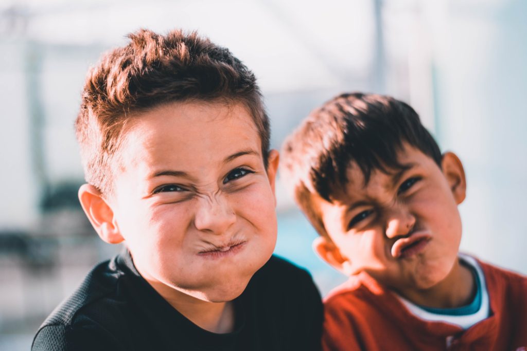 Two young boys making silly faces