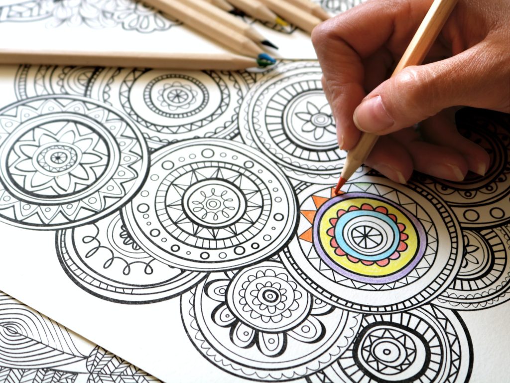 Coloring in mandala style art using color pencil