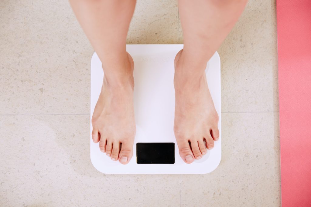 Standing on a weight scale.