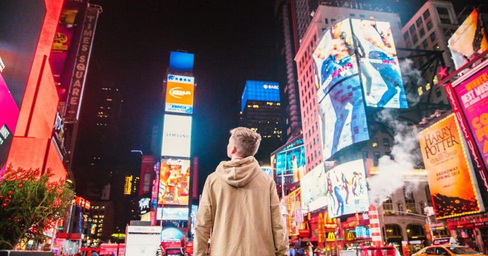 Young man standing in Times Square