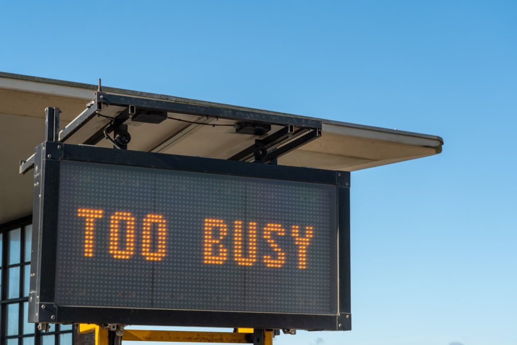 An electronic road sign displaying the words "too busy"